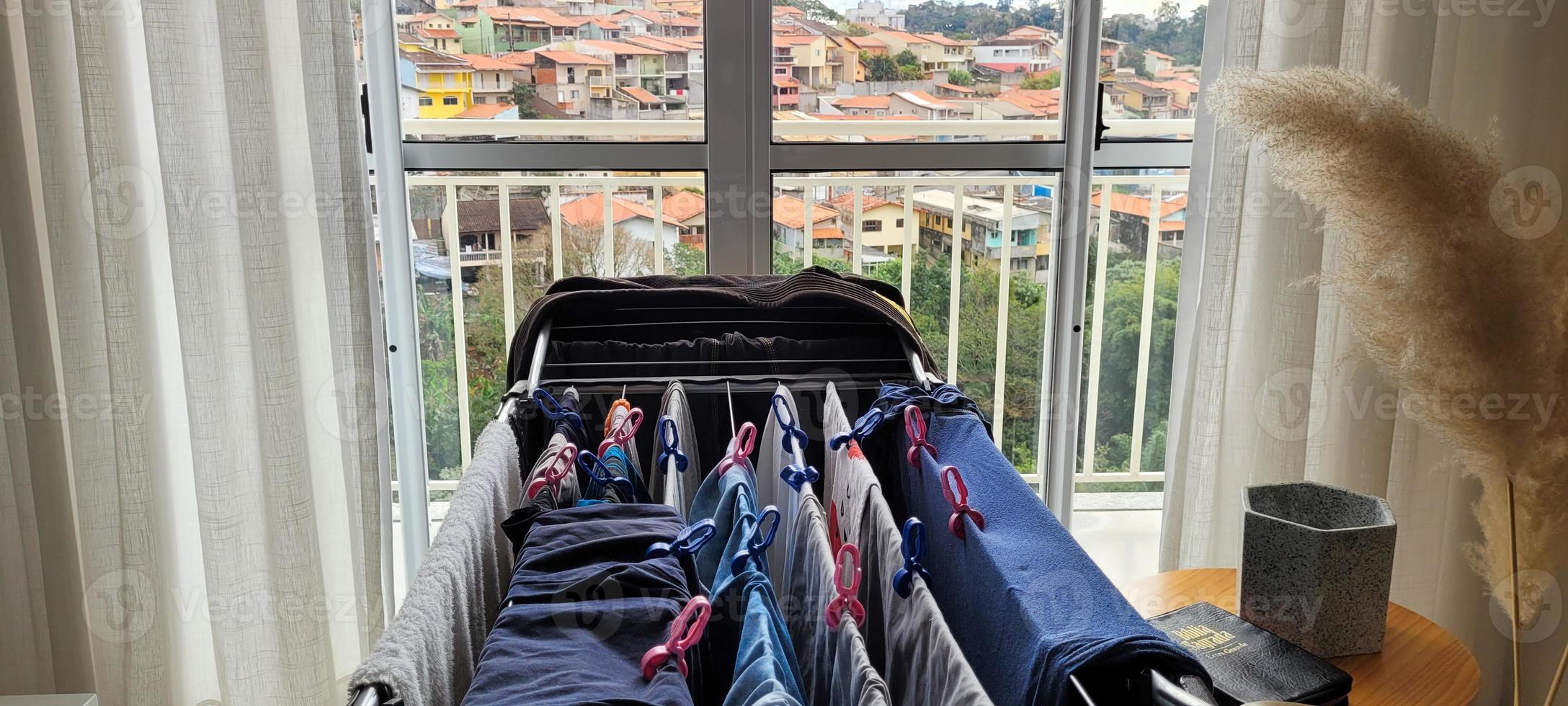 washed clothes hanging on clothesline in apartment photo
