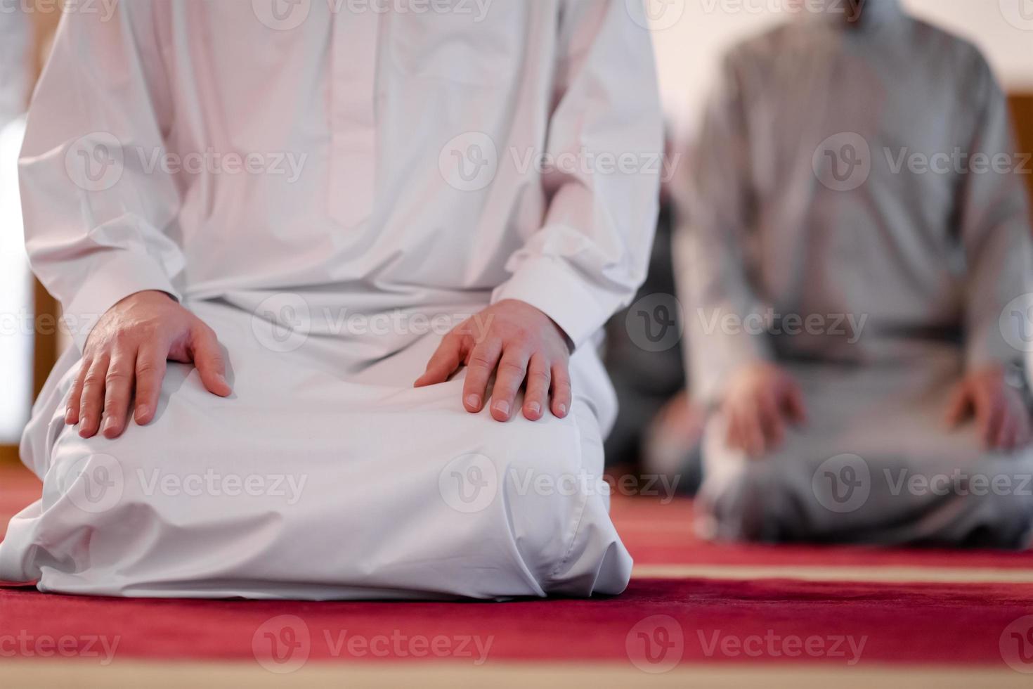 group of muslim people praying namaz in mosque. photo