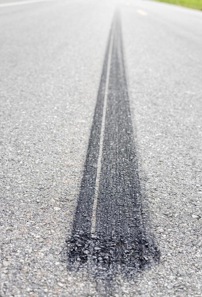 Close-up low view background, black tire traces of automobile wheels which stop braking severely stuck. photo