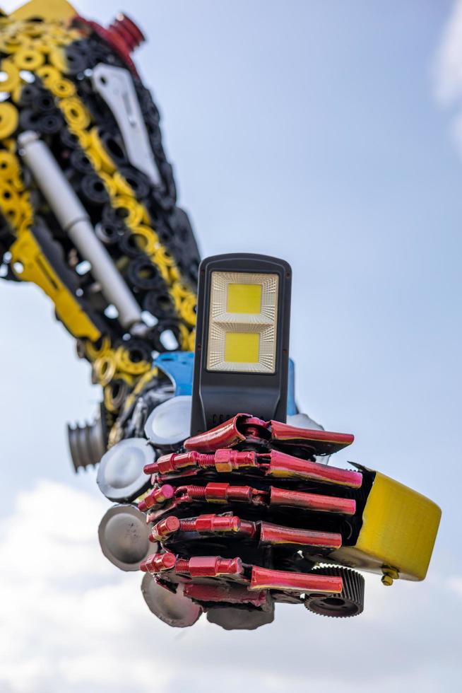 A low angle view of the robot's arm, which has been creatively crafted by using old steel. photo