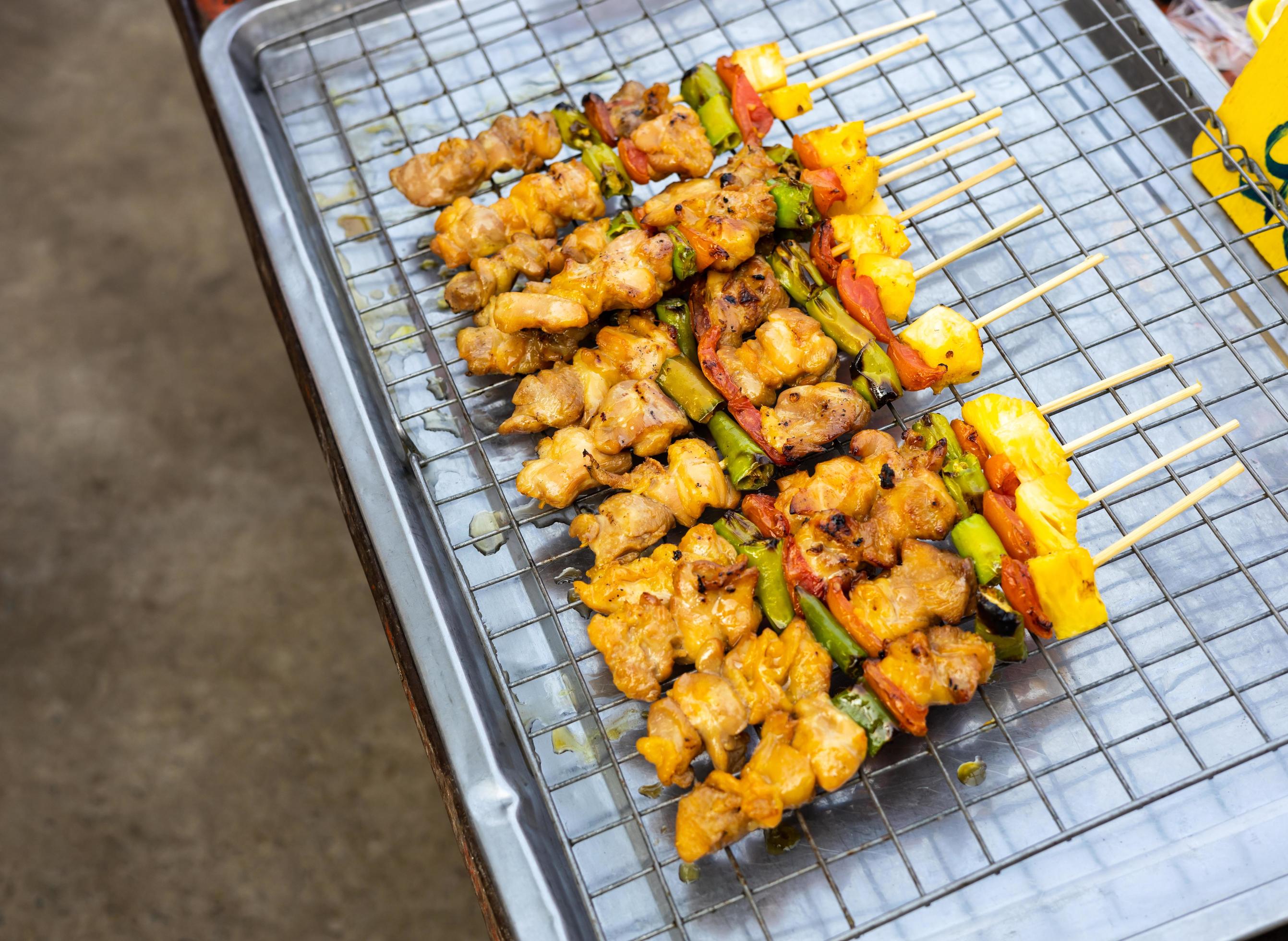 Barbecued skewers are grilled and placed on a stainless steel skewer