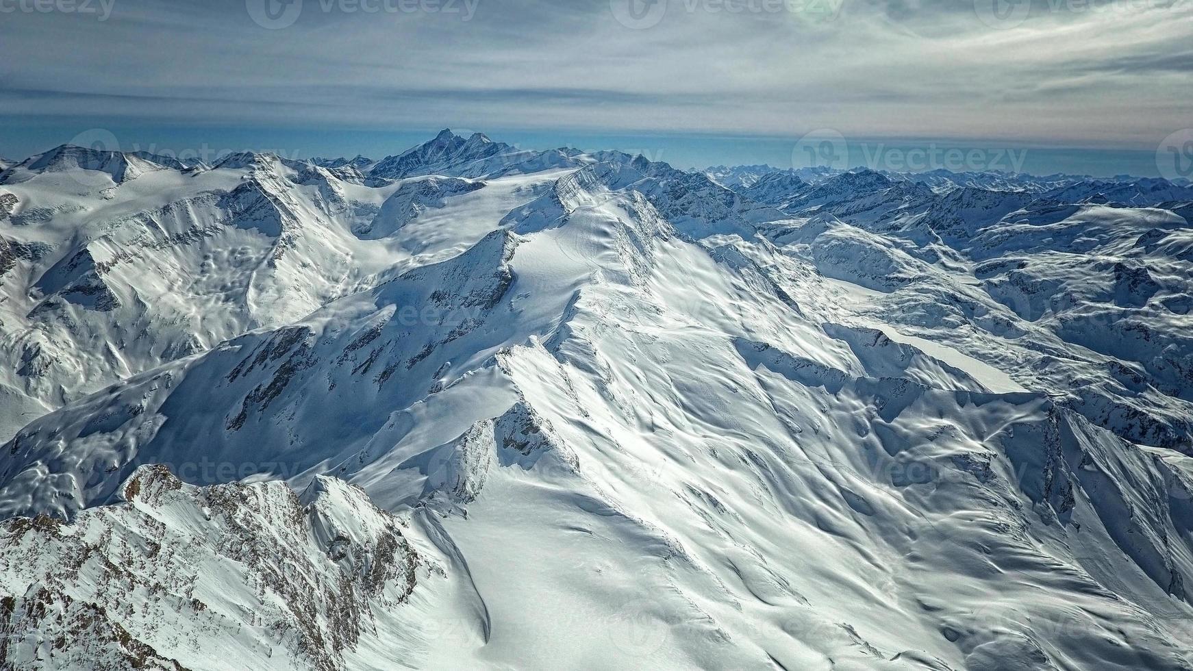 Amazing view from a drone over the snowy mountain hills photo