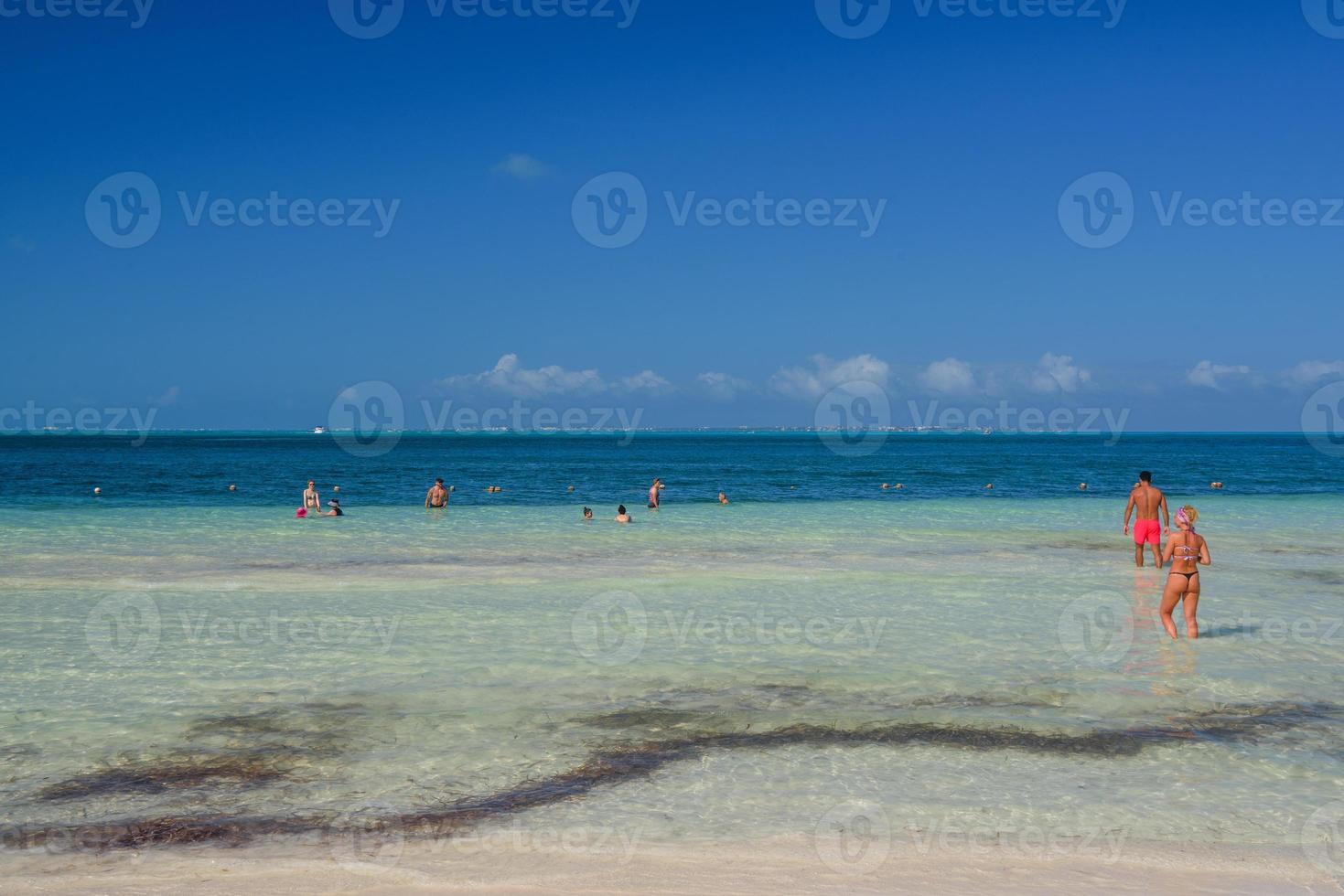 Sexy girl in string tanga bikini on the beach on a sunny day in Cancun, Yukatan, Mexico photo