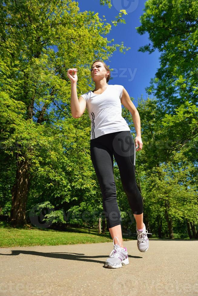 Young beautiful  woman jogging at morning in park photo