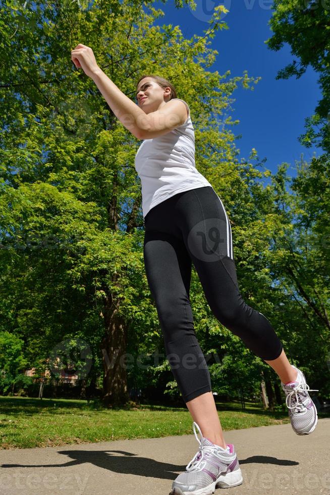 Young beautiful  woman jogging at morning in park photo
