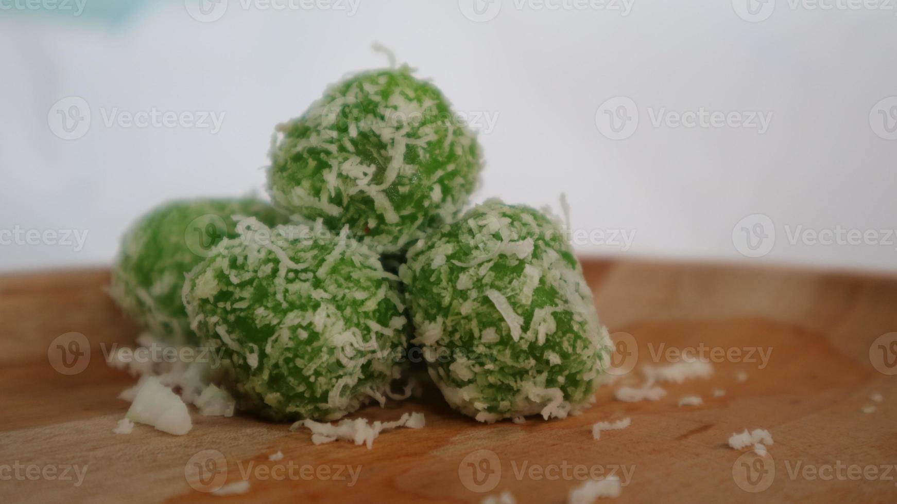 Green klepon cake sprinkled with grated coconut photo