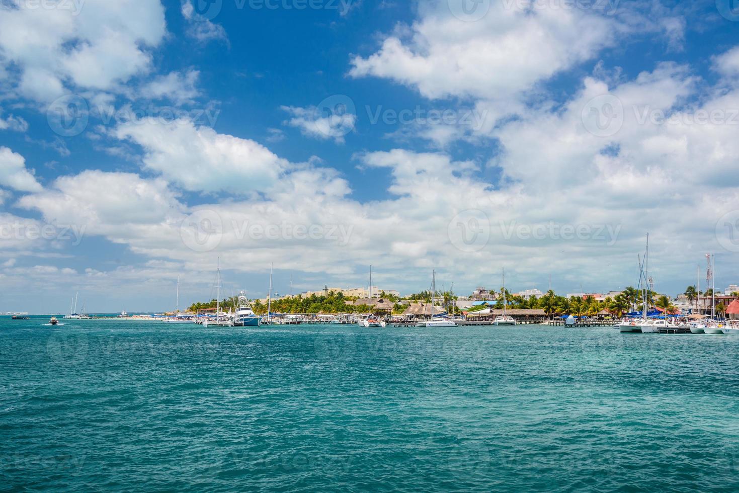 Port with sailboats and ships in Isla Mujeres island in Caribbean Sea, Cancun, Yucatan, Mexico photo