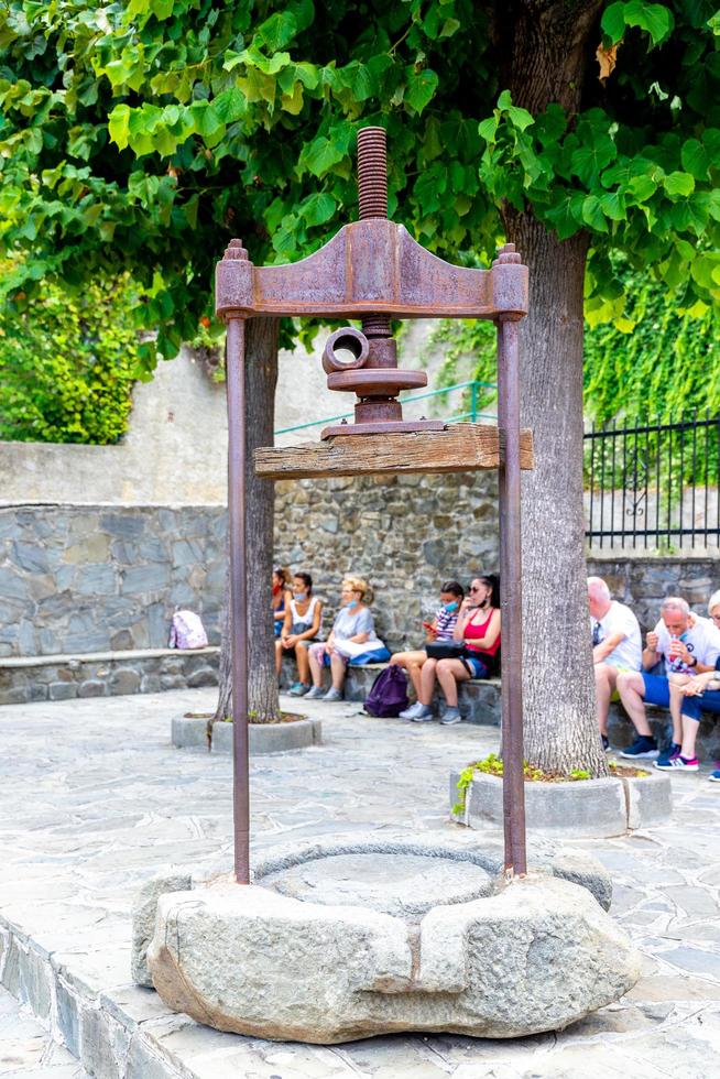 Old oil press on a square photo