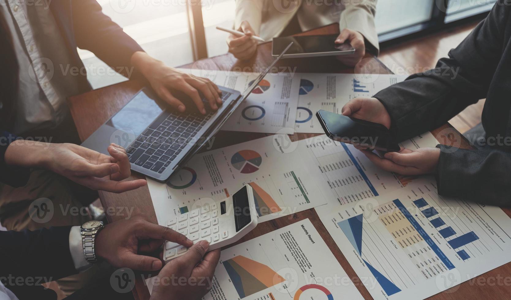 Business team analyzing income charts and graphs with modern laptop computer. Close up.Business analysis and strategy concept. photo