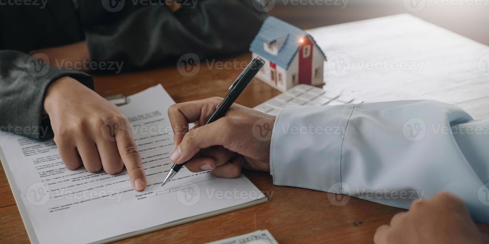 Real estate company to buy houses and land are delivering keys and houses to customers after agreeing to make a home purchase agreement and make a loan agreement. Discussion with a real estate agent photo