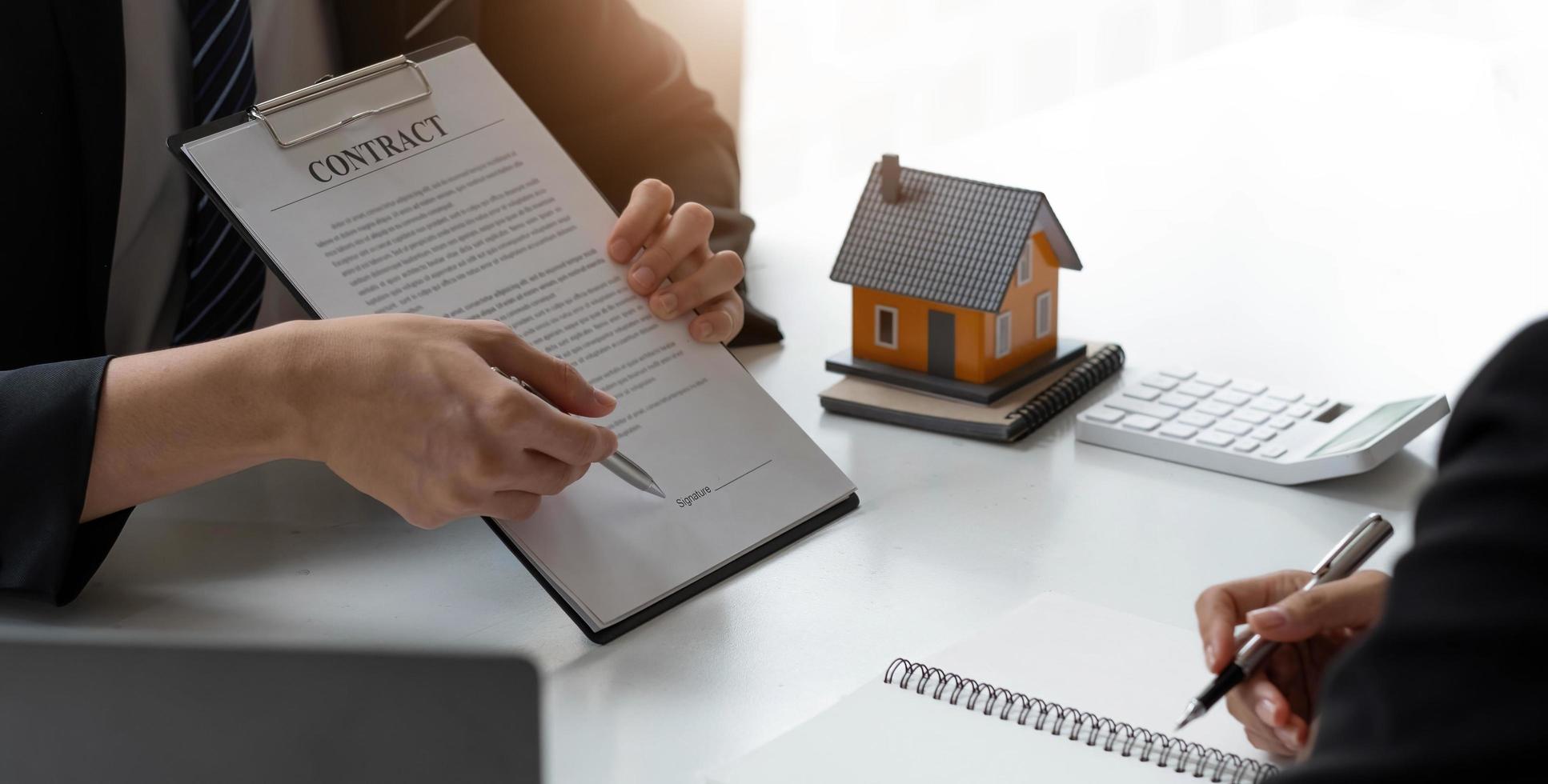 Business Signing a Contract Buy - sell house, Home for rent concept, broker agent presenting and consult detail to customer to making the decision a home estate loan to customer sign form agreement. photo