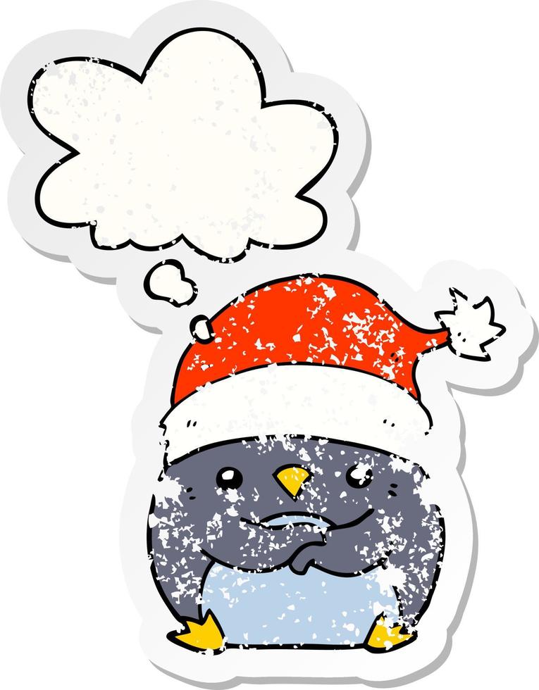 lindo pingüino de dibujos animados con sombrero de navidad y burbuja de pensamiento como una pegatina desgastada y angustiada vector