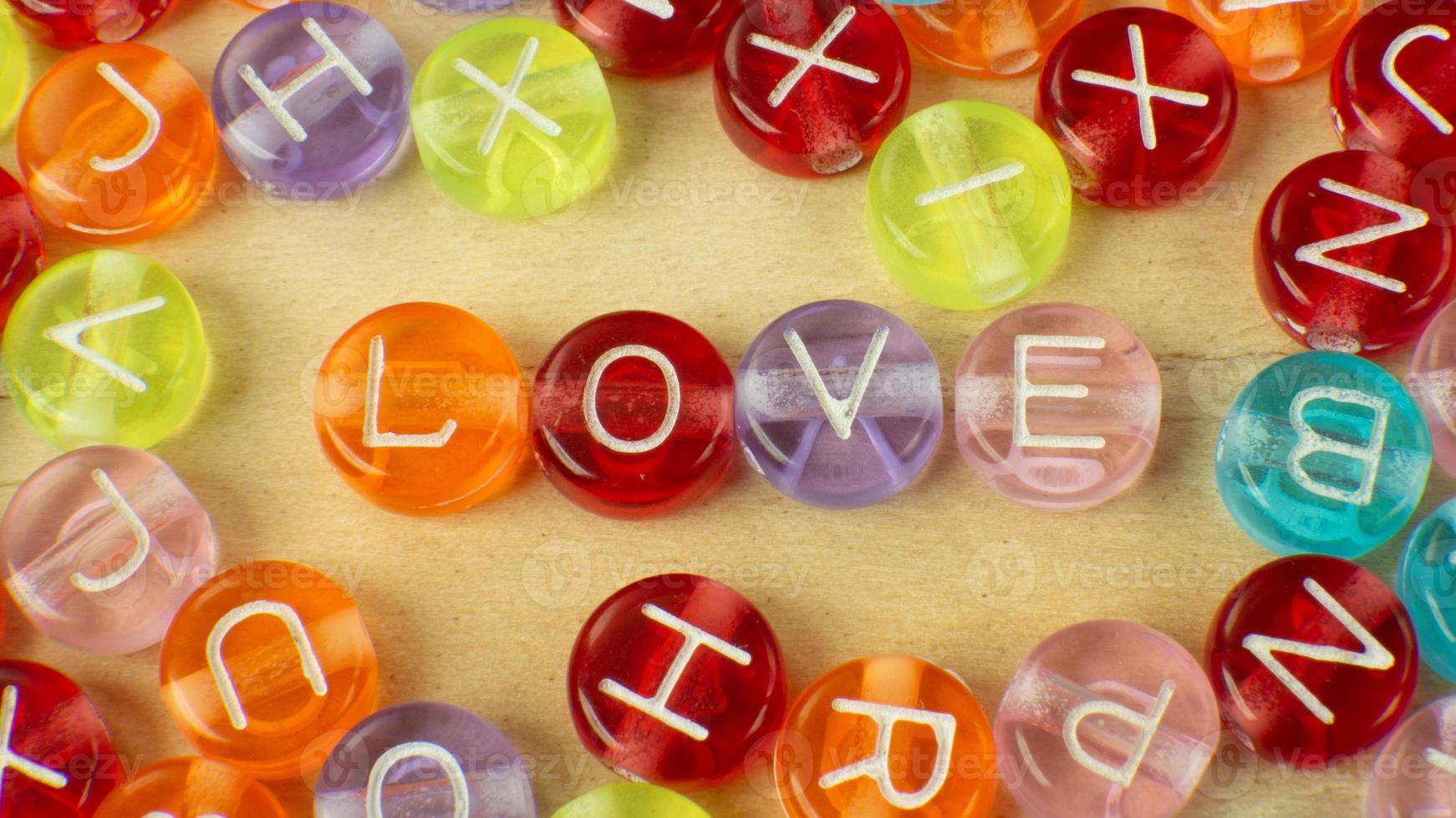 The love word on alphabet bead multi color for background content photo