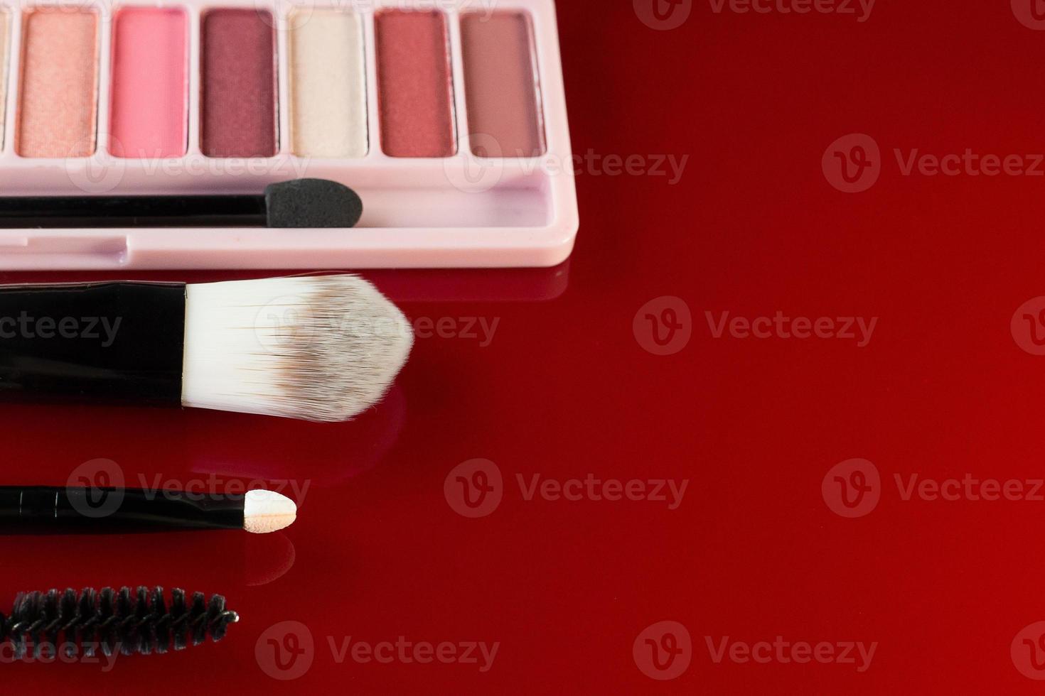 The cosmetics  on red glossy plate top view image.he cosmetics  on red glossy plate photo