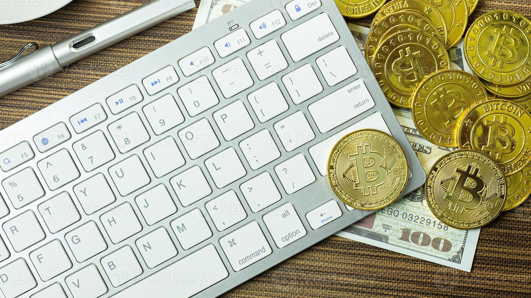 Bitcoin coin on silver keyboard for  cryptocurrency content. photo