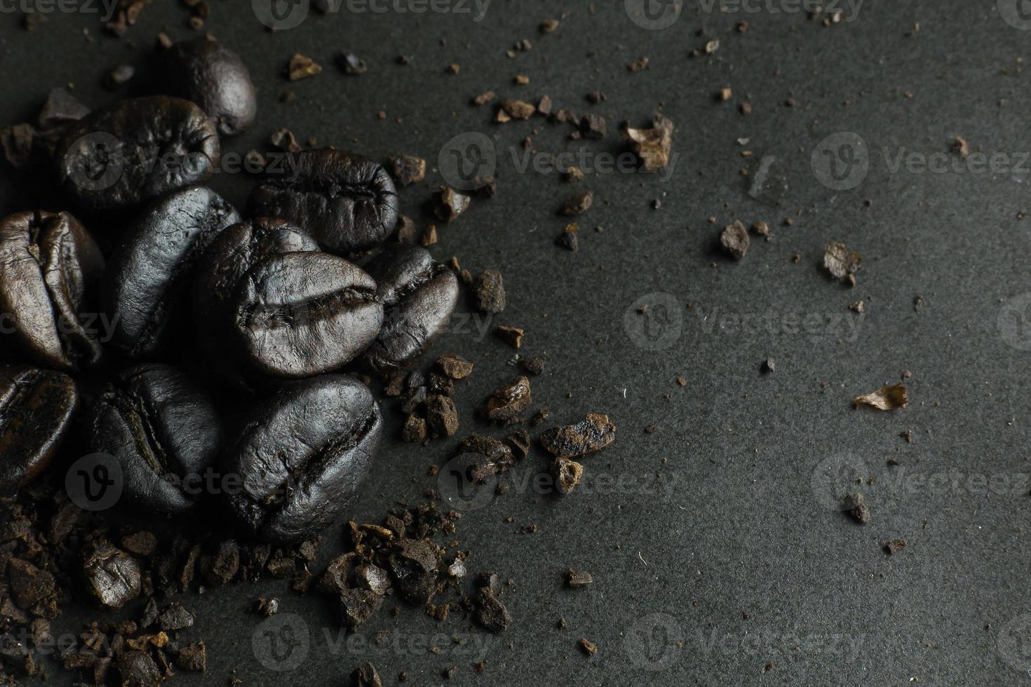 The  coffee roasted on  black texture close up background. photo