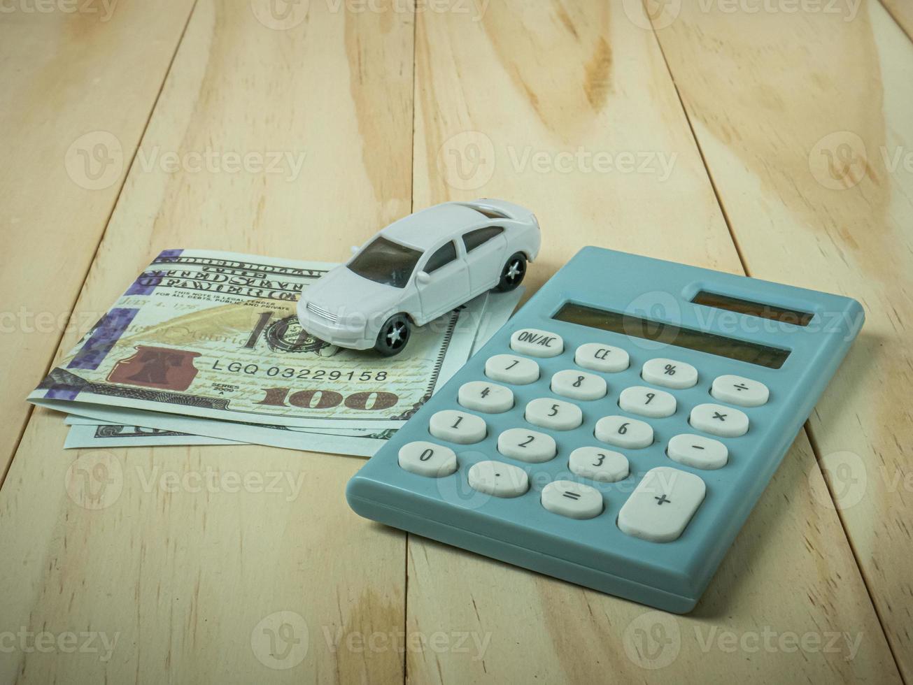 car and calculator on wood table for business content. photo