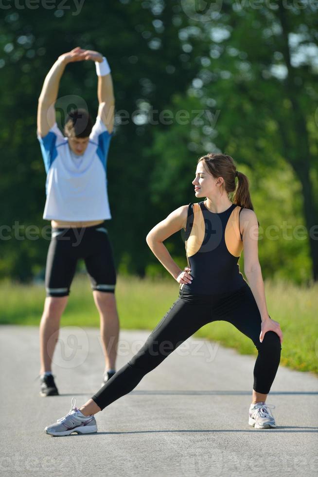 people doing stretching exercise  after jogging photo