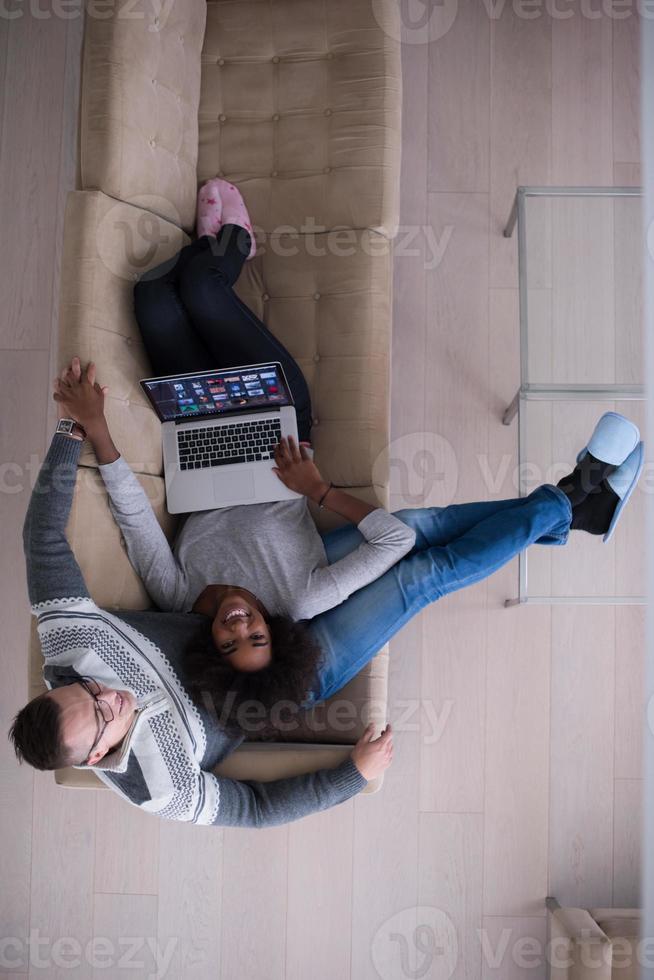 happy multiethnic couple relaxes in the living room photo