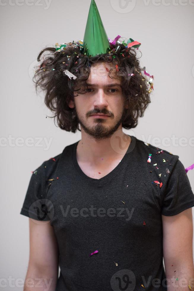 man blowing confetti in the air photo