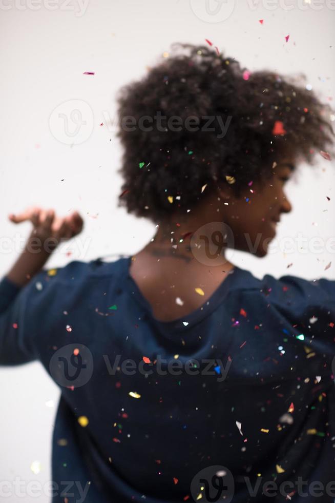 African American woman blowing confetti in the air photo