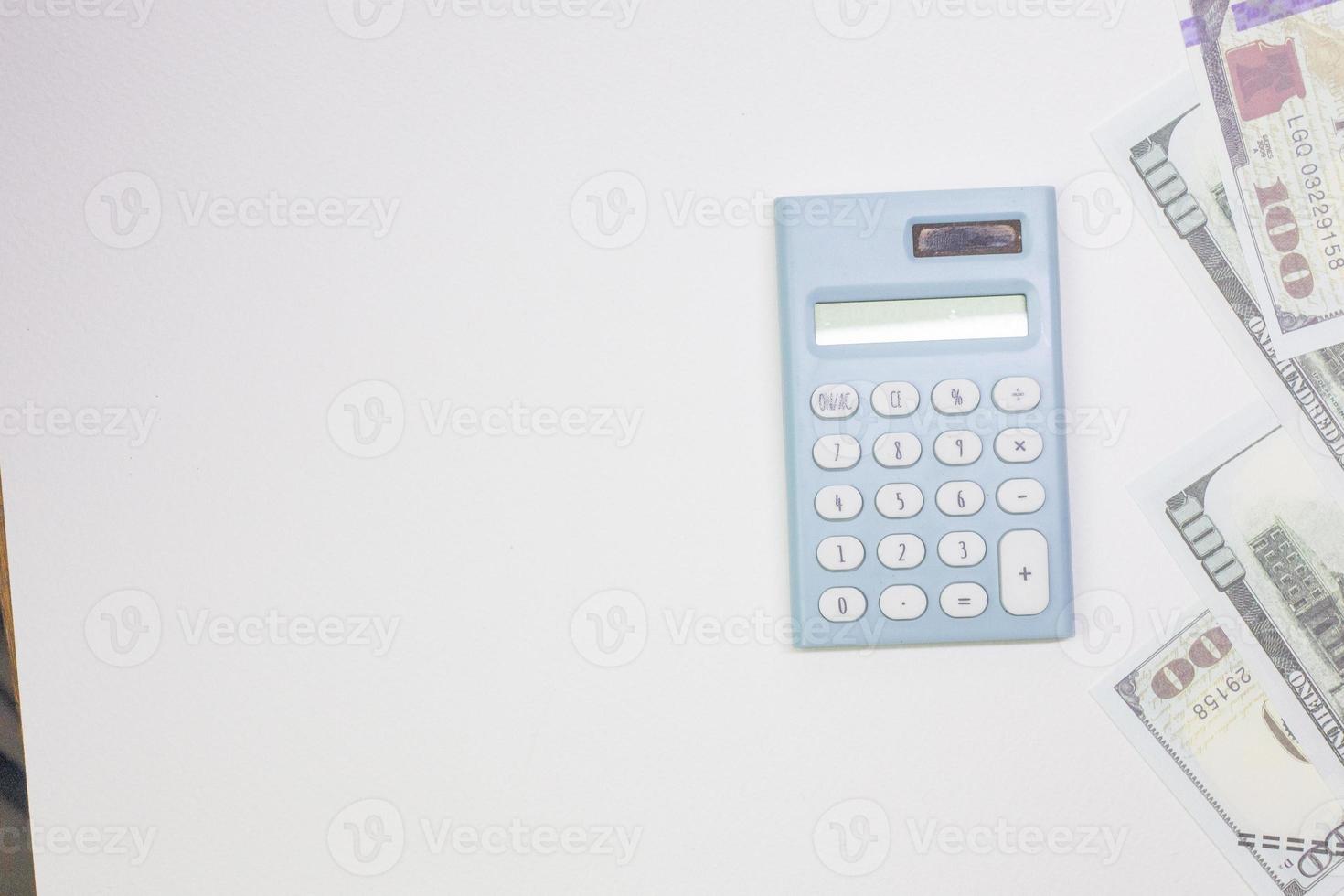 blue calculator and banknotes on white back ground. photo