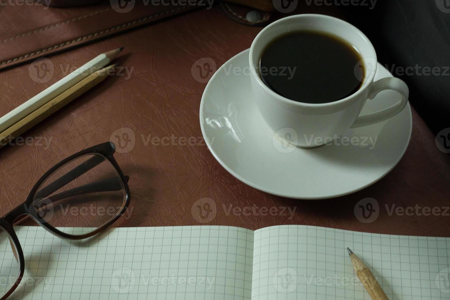 Coffee cup and coffee beans on wooden vintage image background. photo