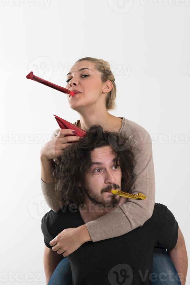 couple in party hats blowing in whistle photo