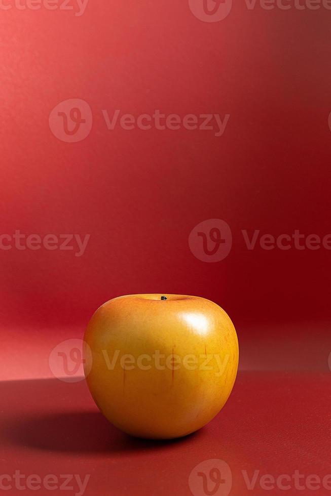 Apple on red background low light for food content. photo