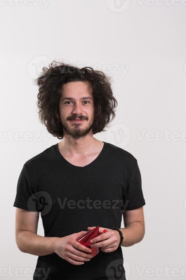 Portrait of a man in party hat blowing in whistle photo