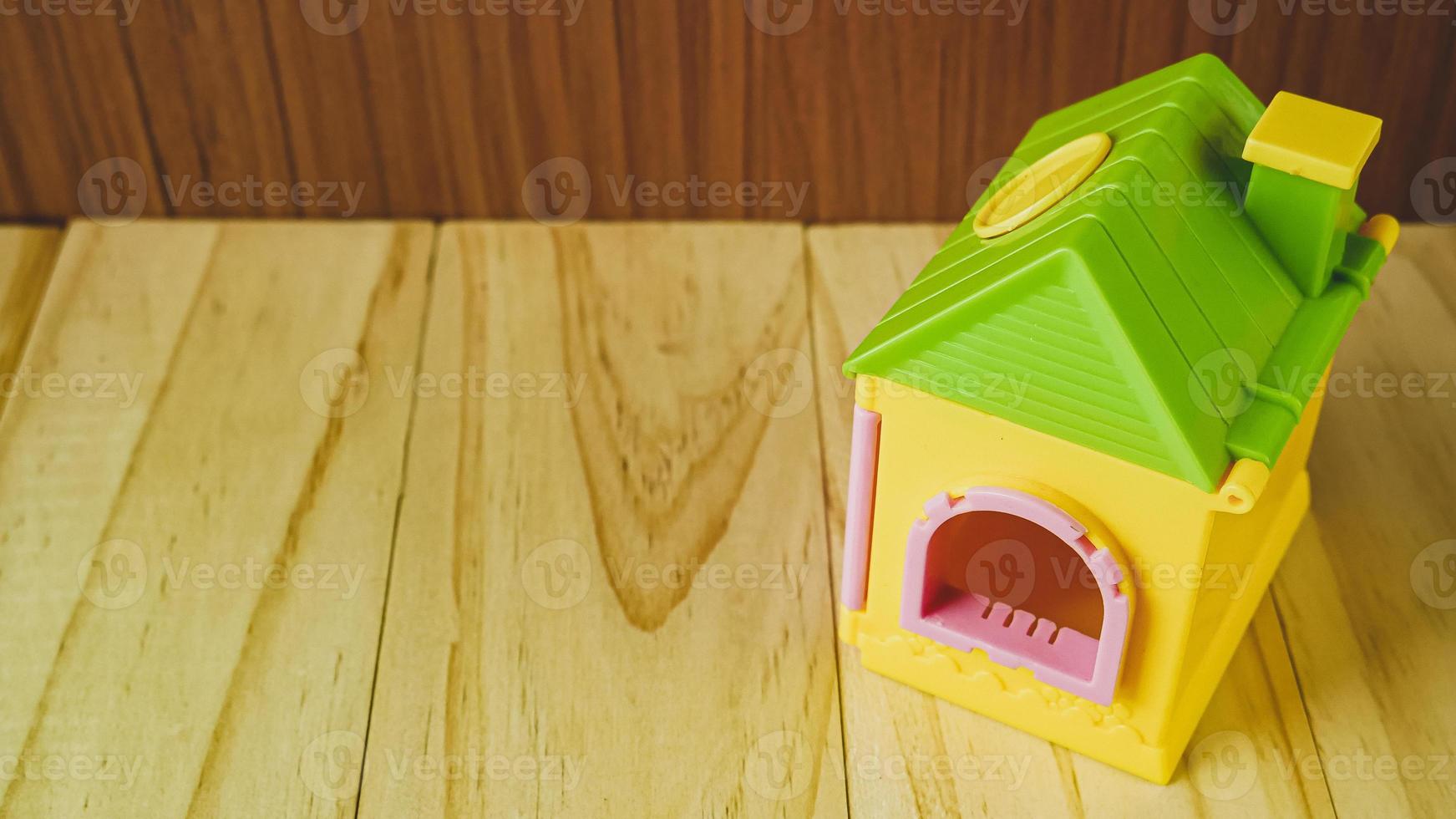 The home toy on wood table for property and building content. photo