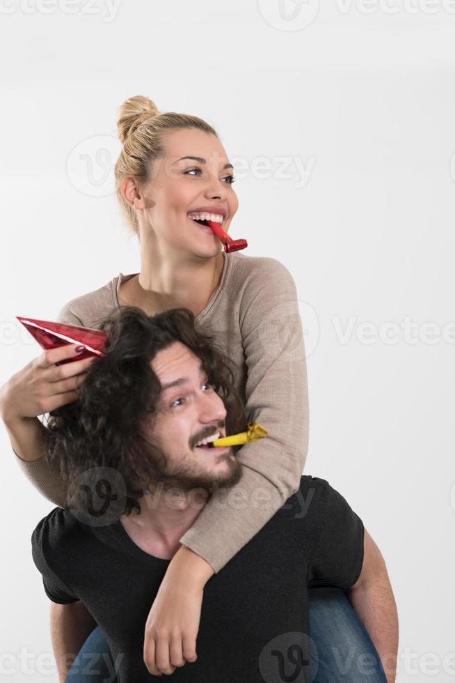 couple in party hats blowing in whistle photo
