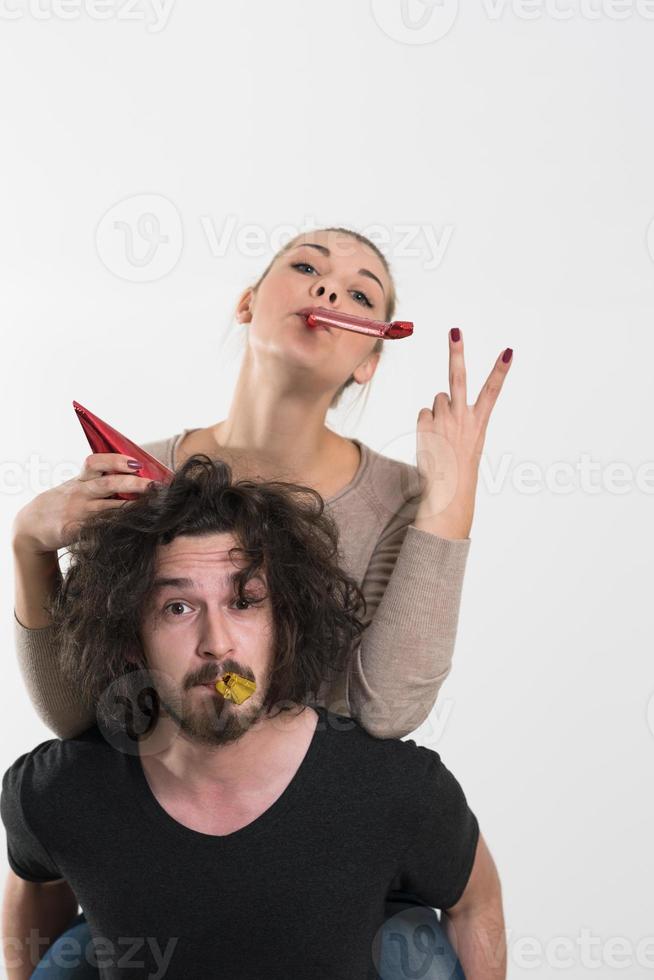 couple in party hats blowing in whistle photo
