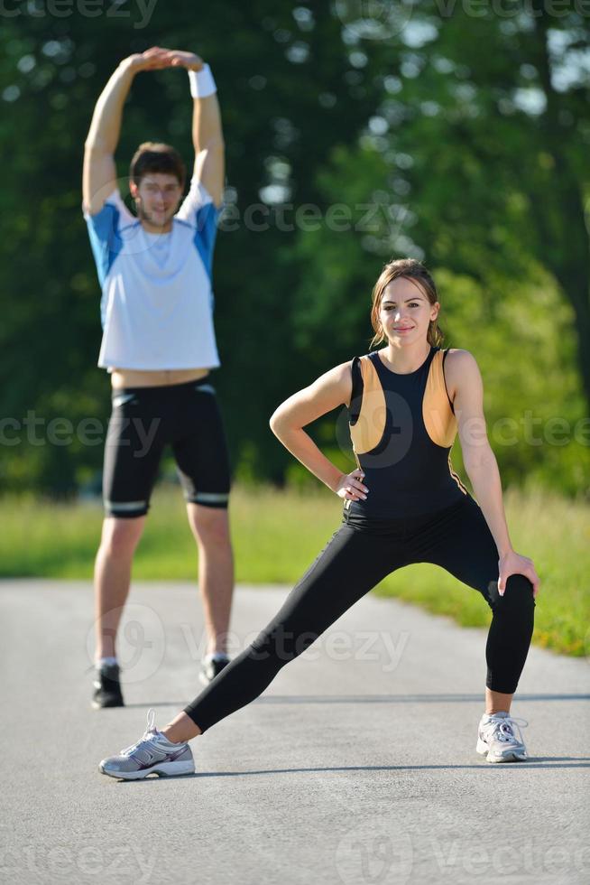 people doing stretching exercise  after jogging photo