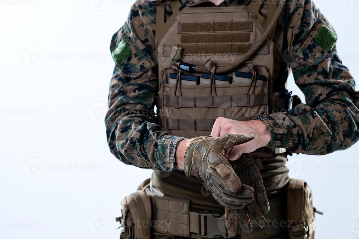 closeup of soldier hands putting protective battle gloves photo