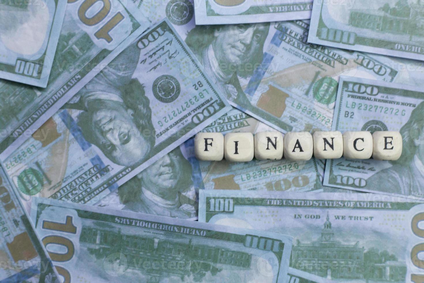 Finance word on wood brick  background banknote. photo