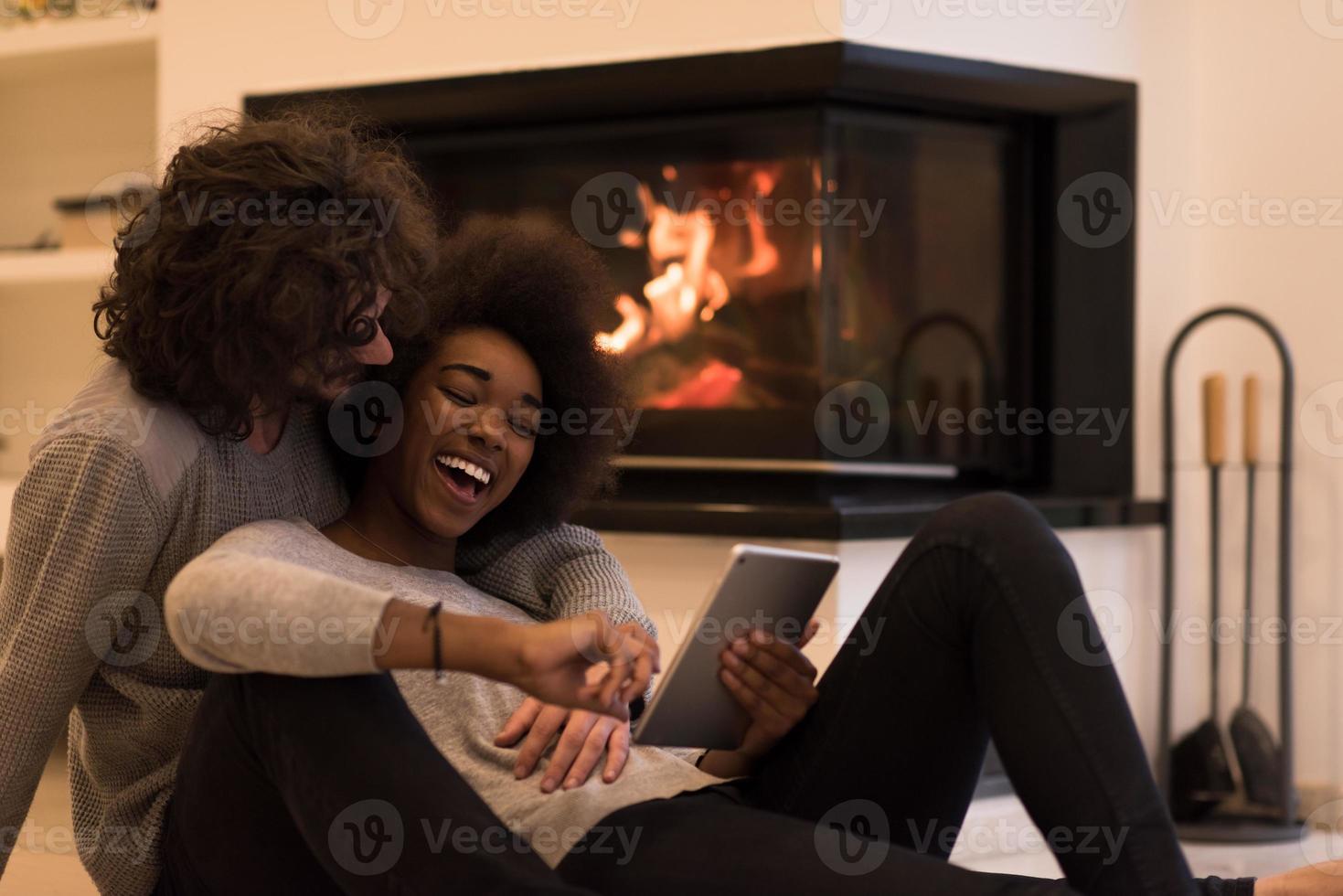 multiethnic couple using tablet computer on the floor photo