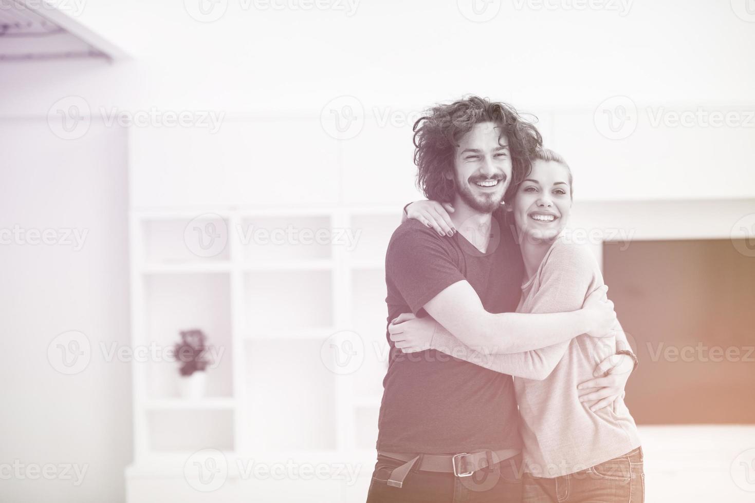 couple hugging in their new home photo