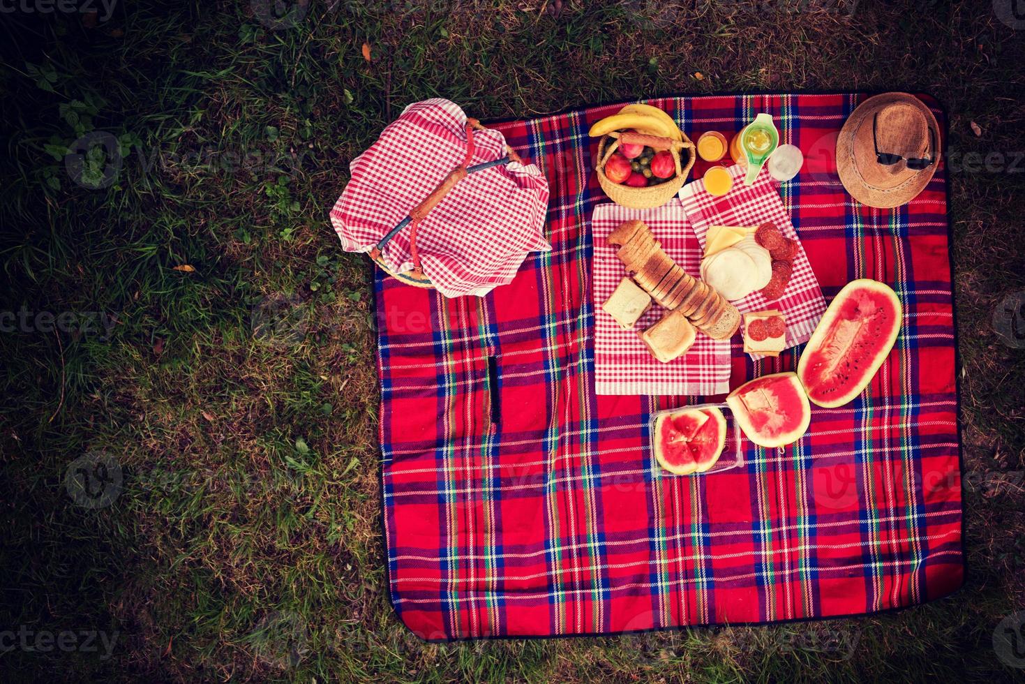 top view of picnic blanket setting on the grass photo