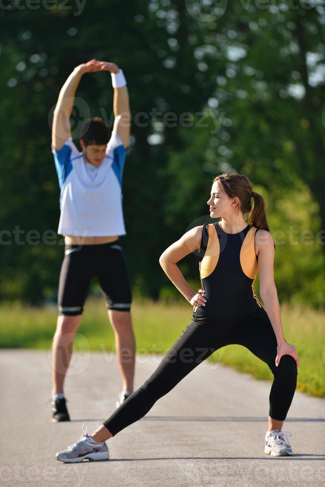Couple doing stretching exercise  after jogging photo