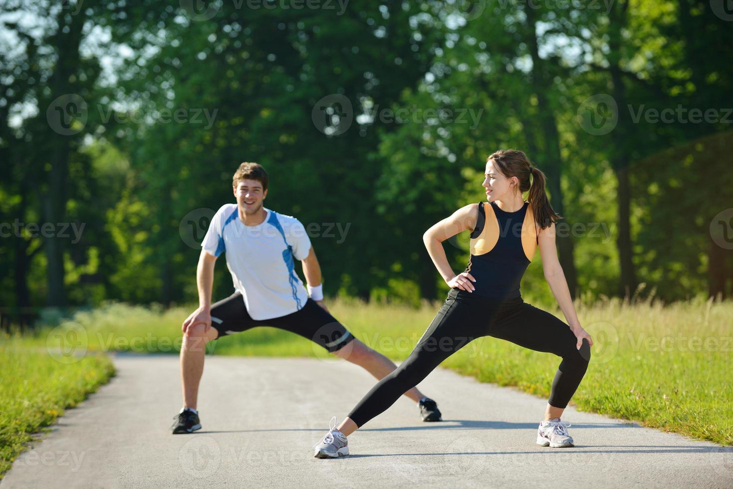 people doing stretching exercise  after jogging photo