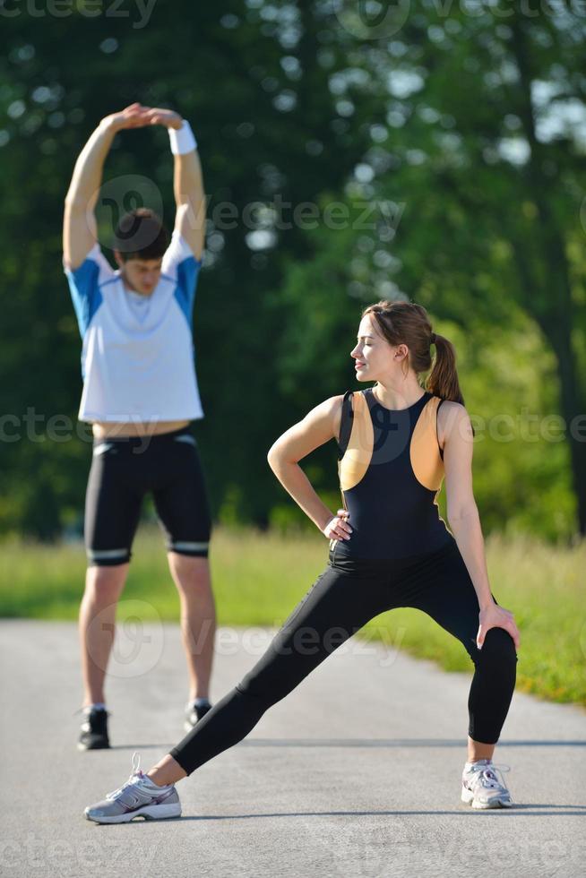 people doing stretching exercise  after jogging photo