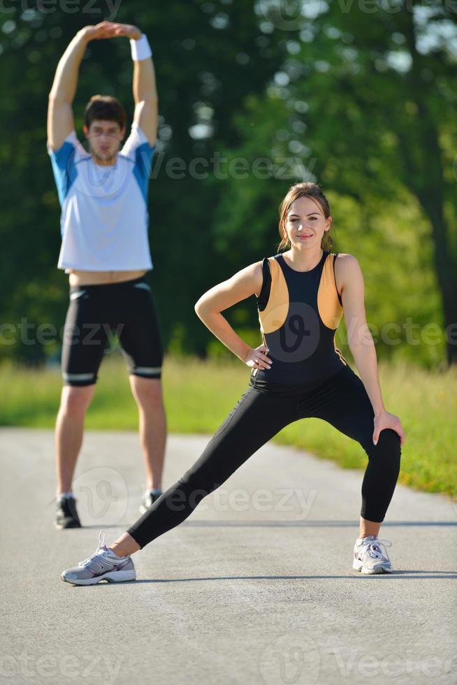 Couple doing stretching exercise  after jogging photo