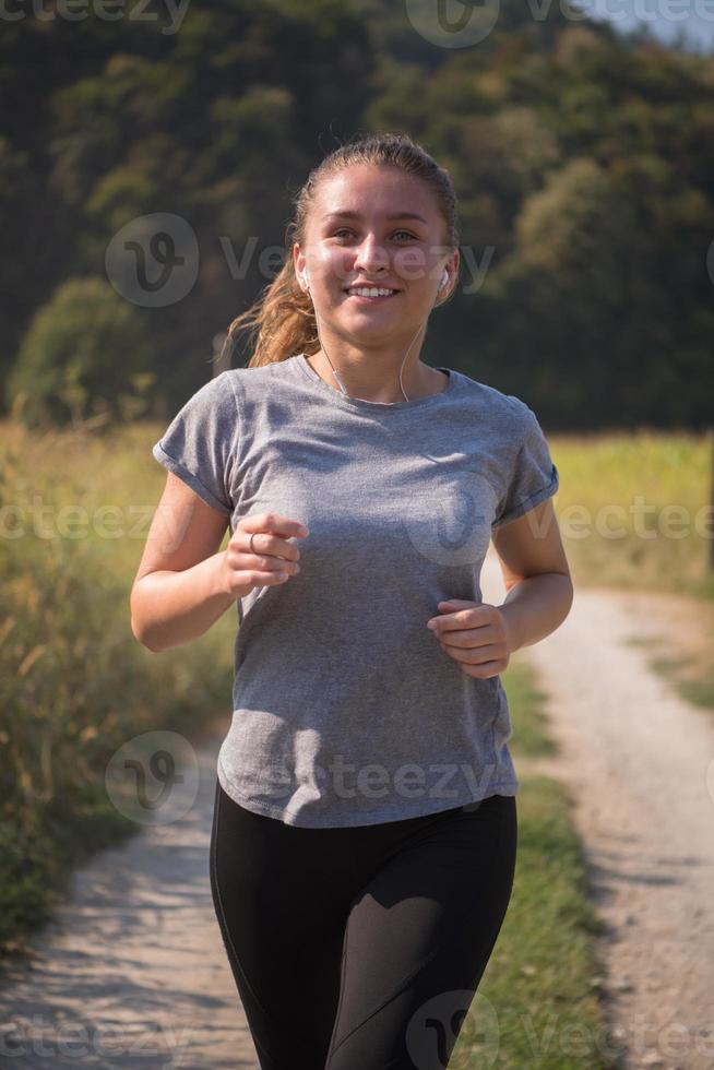 woman jogging along a country road photo