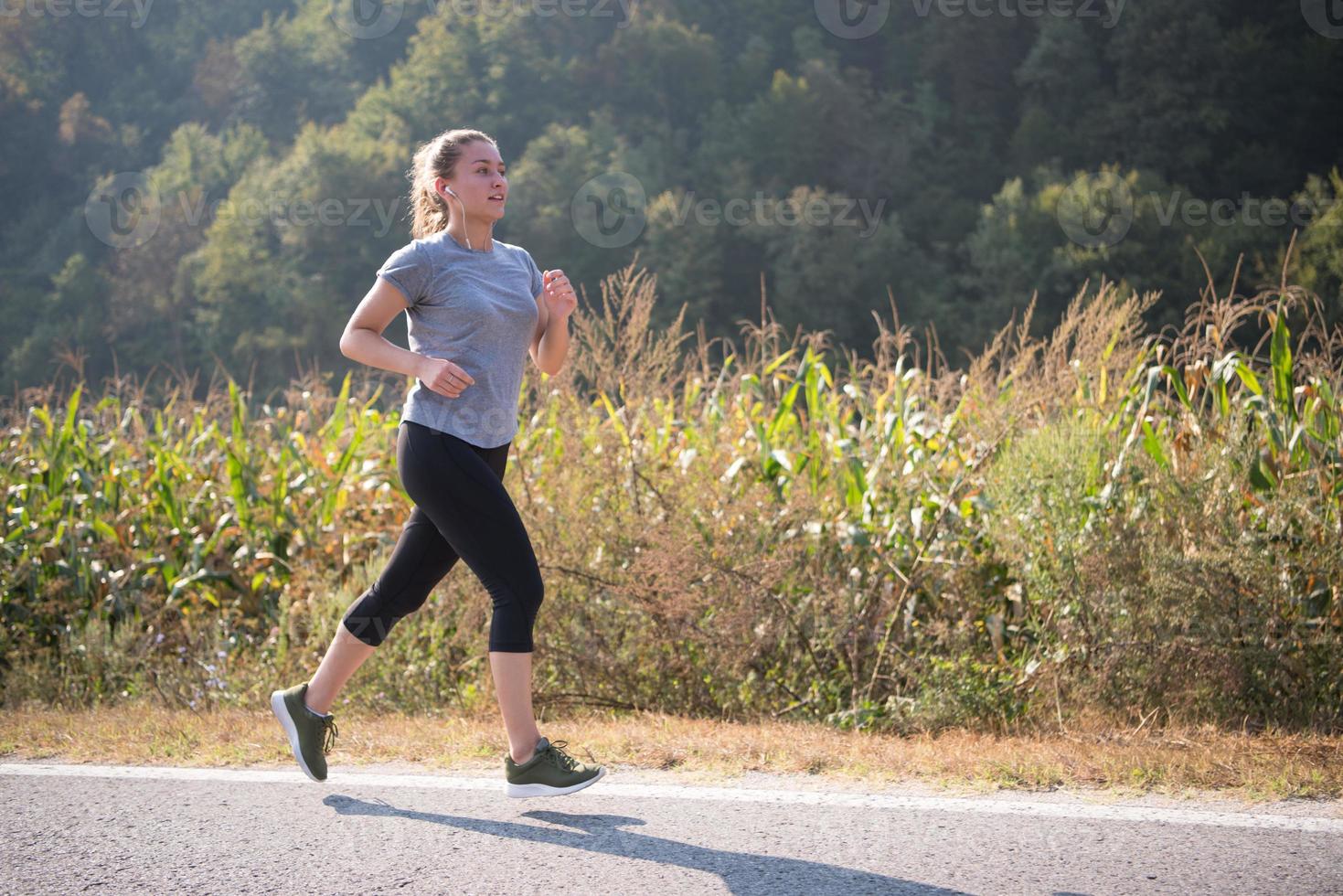 woman jogging along a country road photo