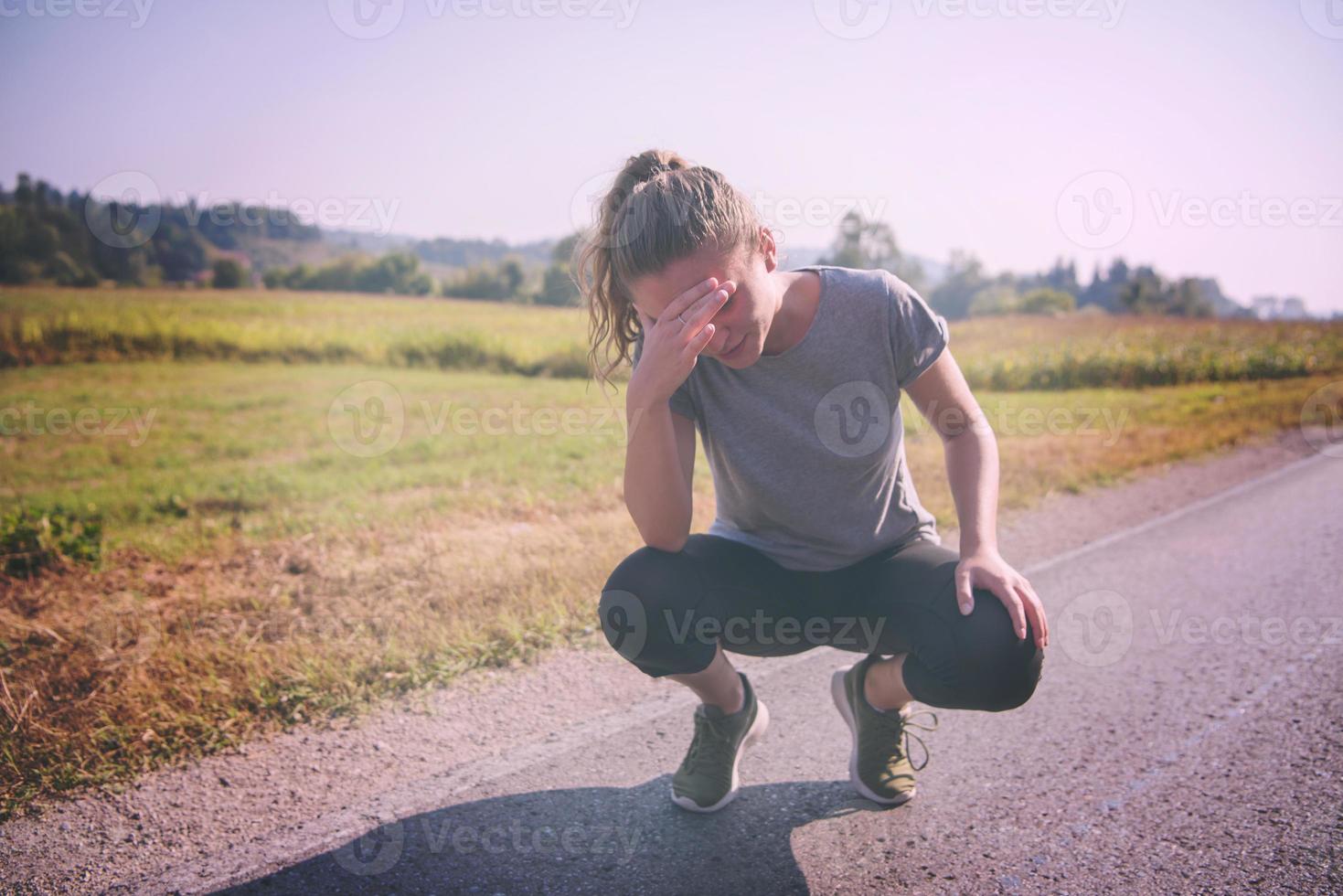 woman jogging along a country road photo