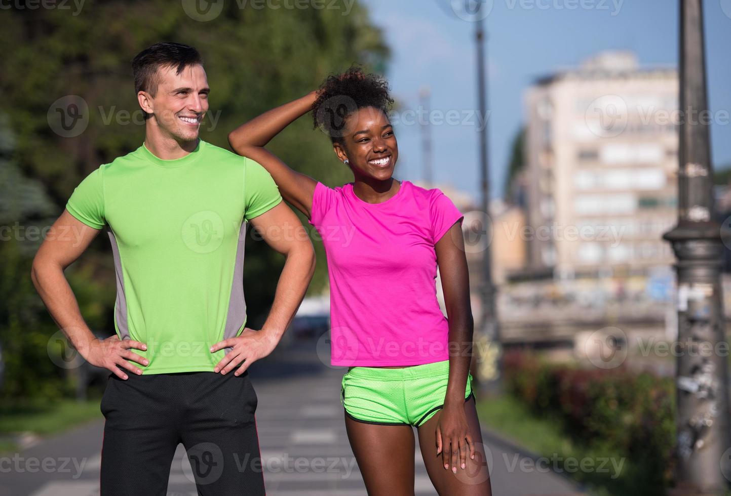 portrait of young multietnic jogging couple ready to run photo