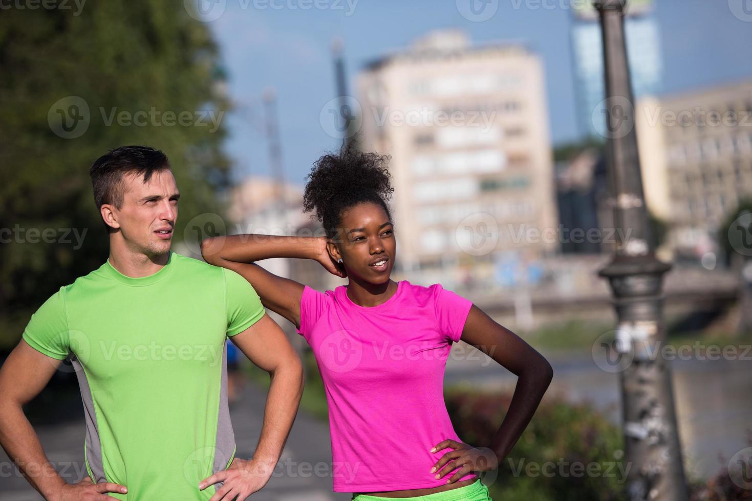portrait of young multietnic jogging couple ready to run photo