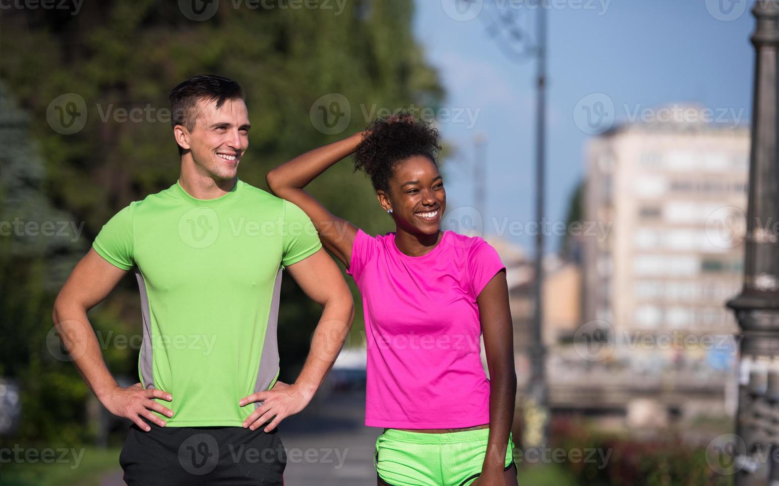 portrait of young multietnic jogging couple ready to run photo