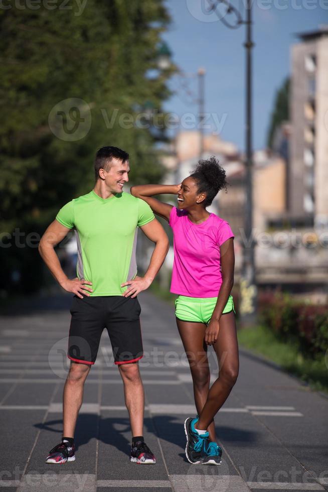 portrait of young multietnic jogging couple ready to run photo